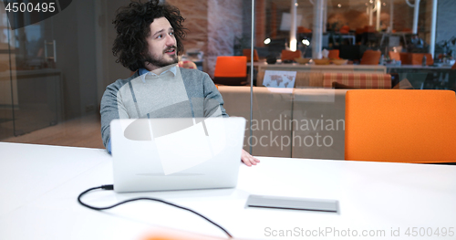 Image of businessman working using a laptop in startup office