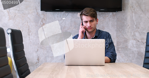 Image of businessman working using a laptop in startup office