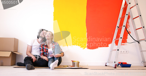 Image of Happy young couple relaxing after painting