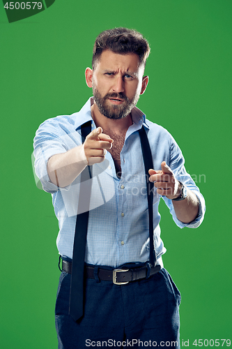 Image of The overbearing businessman point you and want you, half length closeup portrait on green background.
