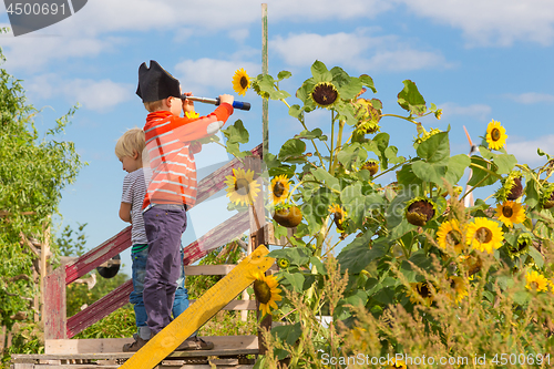 Image of Kids playing pirates in urban gardens at Tempelhofer field, once airport, now a public park in Berlin, Germany