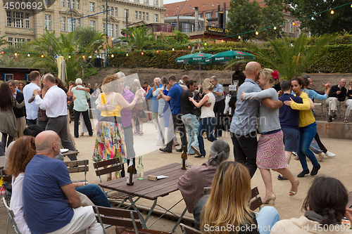 Image of People dancing salsa outdoors at city square on one of many summer events in Berlin, Germany on 28th of september, 2016.