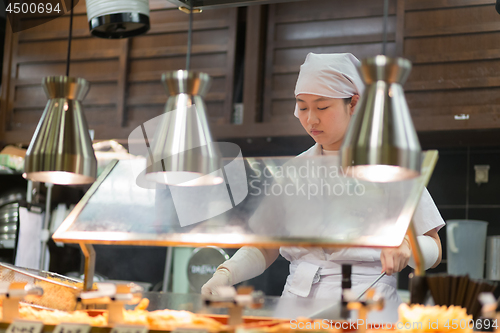 Image of Japanese Ramen chefs prepare a bowl of traditional home made ramen noodle for customers in Kyoto, Japan.