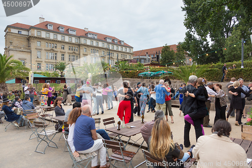 Image of People dancing salsa outdoors at city square on one of many summer events in Berlin, Germany on 28th of september, 2016.