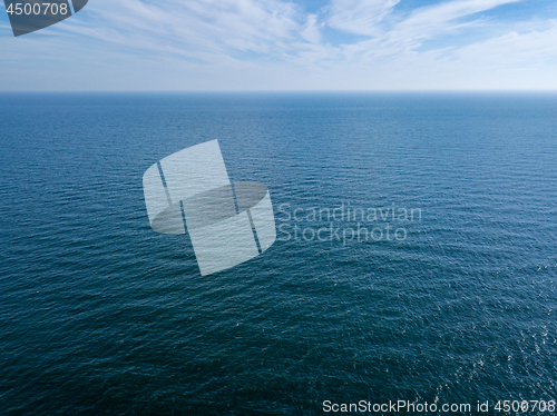 Image of Panoramic view from drone endless blue seascape on a background of cloudy sky. Natural background. Copy space.