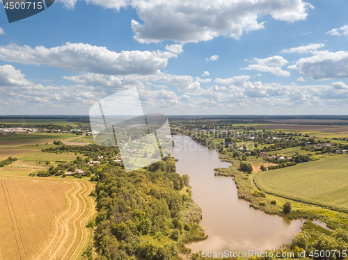 Image of Panoramic view with farmfields, countries, wide river on a background blue cloudy sky in a summer day.