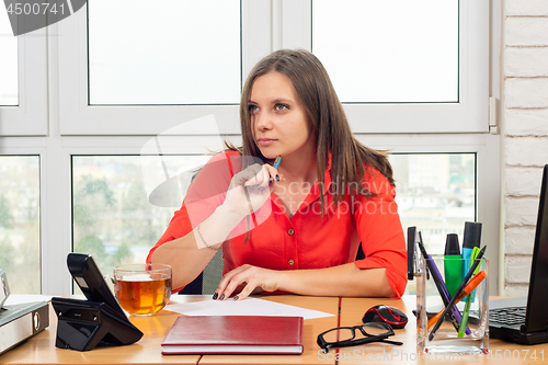 Image of Office employee thought while writing a statement