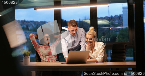 Image of Multiethnic startup business team in night office