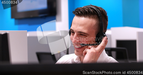 Image of male call centre operator doing his job