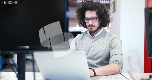 Image of businessman working using a laptop in startup office
