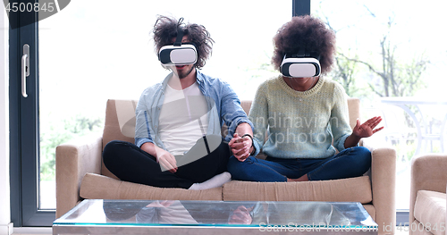 Image of Multiethnic Couple using virtual reality headset