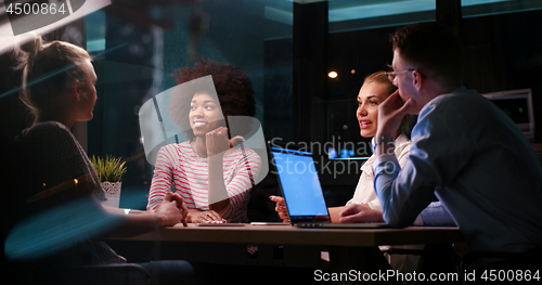 Image of Multiethnic startup business team in night office