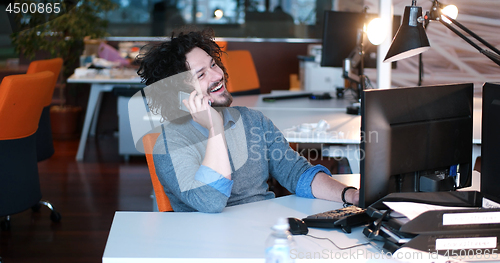 Image of businessman working using a computer in startup office