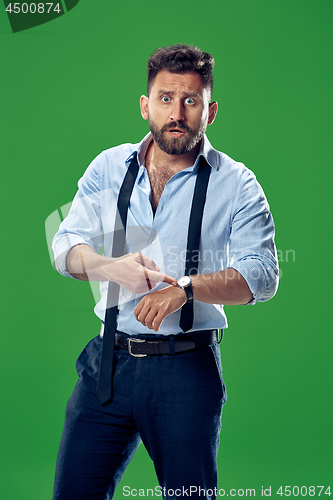 Image of Handsome businessman checking his wrist-watch Isolated on white background