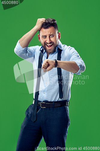 Image of Handsome businessman checking his wrist-watch Isolated on white background