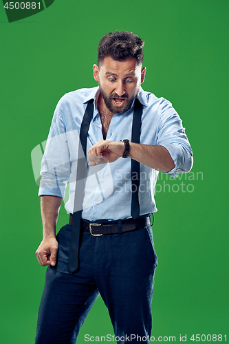 Image of Handsome businessman checking his wrist-watch Isolated on white background