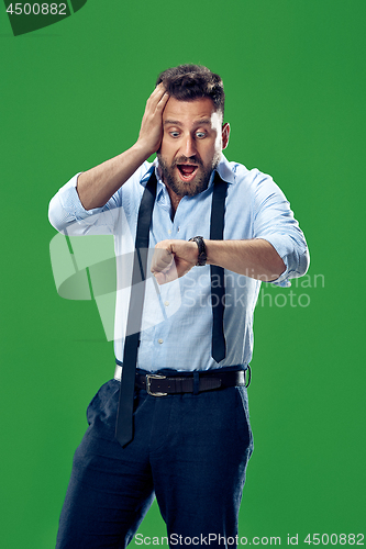 Image of Handsome businessman checking his wrist-watch Isolated on white background