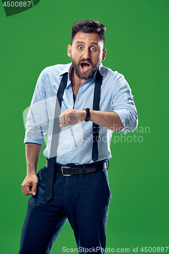 Image of Handsome businessman checking his wrist-watch Isolated on white background