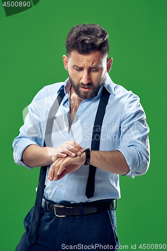 Image of Handsome businessman checking his wrist-watch Isolated on white background