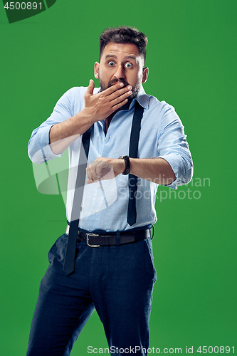 Image of Handsome businessman checking his wrist-watch Isolated on white background