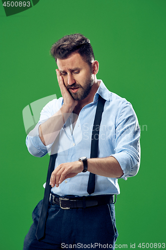 Image of Handsome businessman checking his wrist-watch Isolated on white background