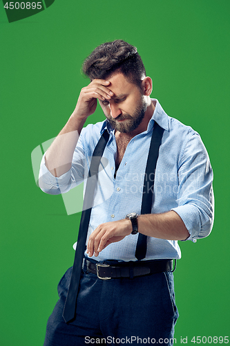 Image of Handsome businessman checking his wrist-watch Isolated on white background