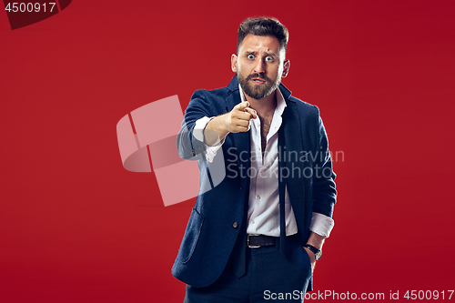 Image of The overbearing businessman point you and want you, half length closeup portrait on red background.