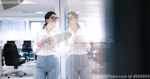 Image of Business Woman Using Digital Tablet in front of Office