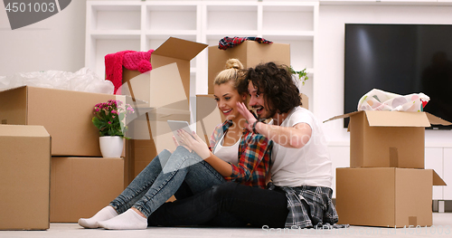 Image of young couple moving  in new house