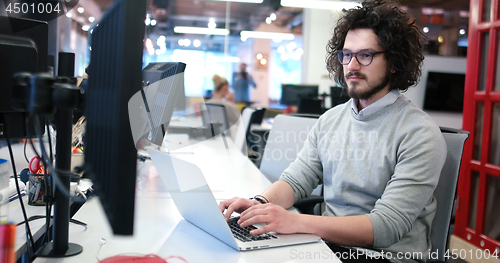 Image of businessman working using a laptop in startup office