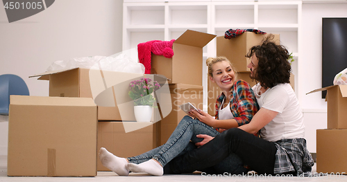 Image of young couple moving  in new house