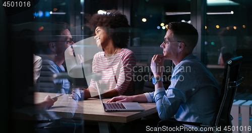 Image of Multiethnic startup business team in night office