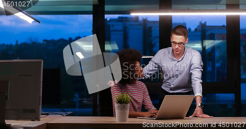 Image of Multiethnic startup business team in night office