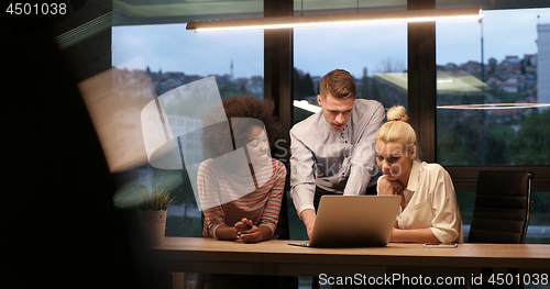 Image of Multiethnic startup business team in night office