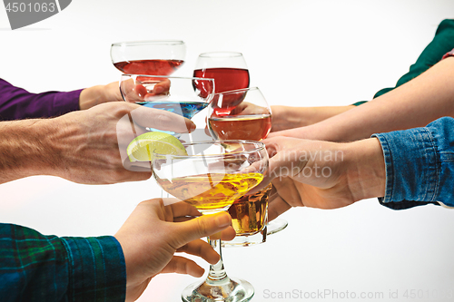 Image of The male and female hands with exotic cocktails