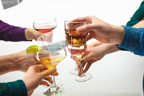 Image of The male and female hands with exotic cocktails