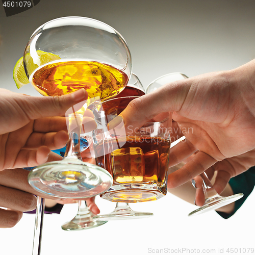 Image of The male and female hands with exotic cocktails