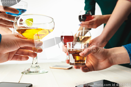 Image of The male and female hands with exotic cocktails