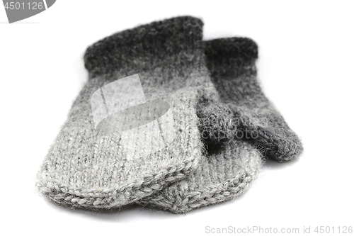 Image of wool gray knitted mittens on a white