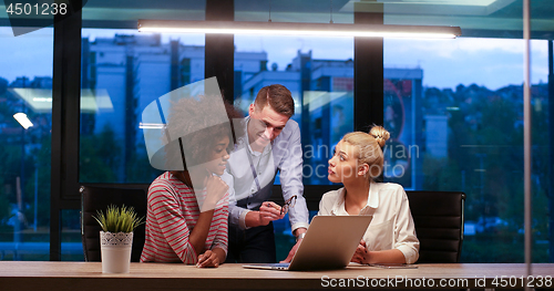 Image of Multiethnic startup business team in night office