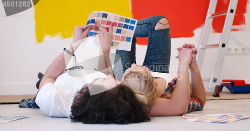 Image of Happy young couple relaxing after painting