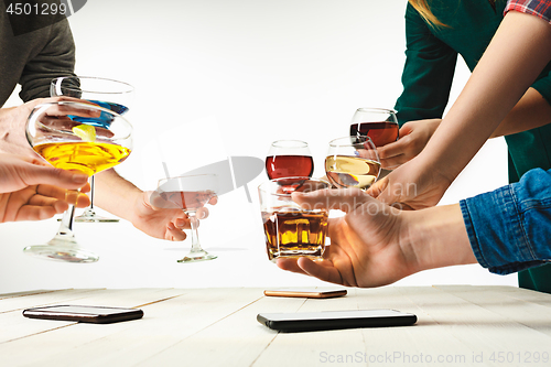 Image of The male and female hands with exotic cocktails