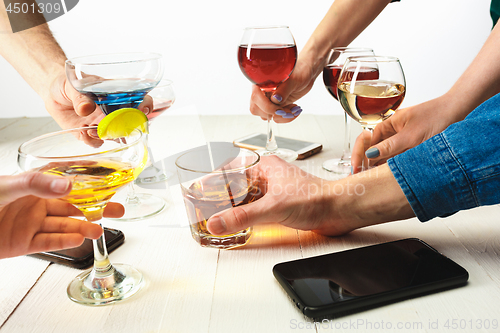 Image of The male and female hands with exotic cocktails