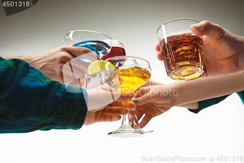 Image of The male and female hands with exotic cocktails