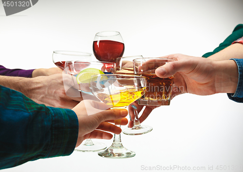 Image of The male and female hands with exotic cocktails