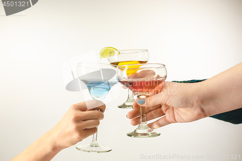 Image of The male and female hands with exotic cocktails