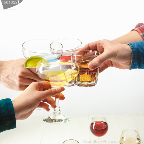 Image of The male and female hands with exotic cocktails