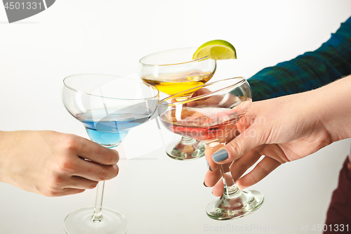 Image of The male and female hands with exotic cocktails