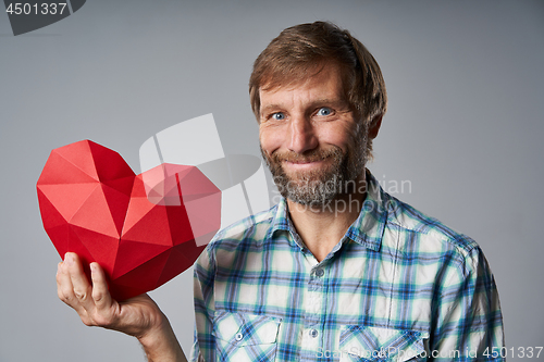 Image of Studio portrait of smiling mature man holding speech bubble