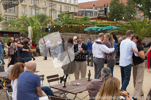 Image of People dancing salsa outdoors at city square on one of many summer events in Berlin, Germany on 28th of september, 2016.